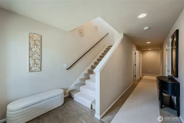 Extra wide stairs with wood railing as you head upstairs to main living area with views. Entry level has 3 sizable bedrooms and a full bathroom. Entry level is not a basement. Light-filled and excellent ceiling height.