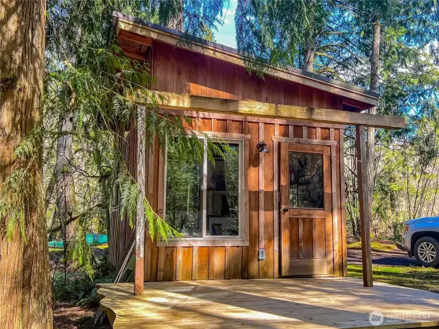 The Host Cabin with sleeping loft, kitchen with gas cooktop, living room and shower.
