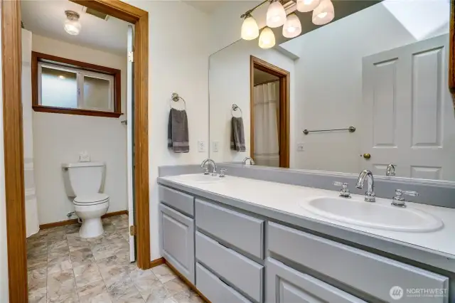 Upstairs full bath with dual vanity.