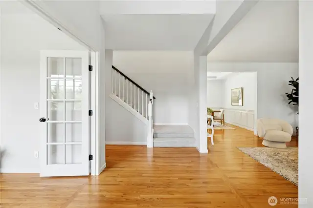 Stepping inside you are met right away with impressive tall ceilings and warm wood flooring.