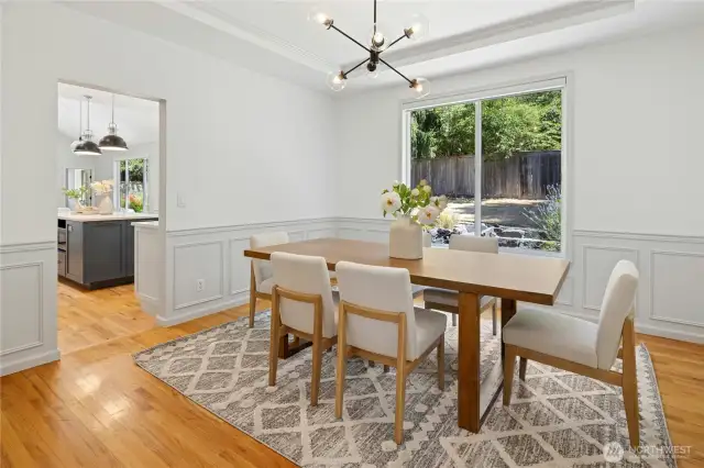 The formal dining room has plenty of room for a large dinner party. Note the lovely millwork and tray ceiling.