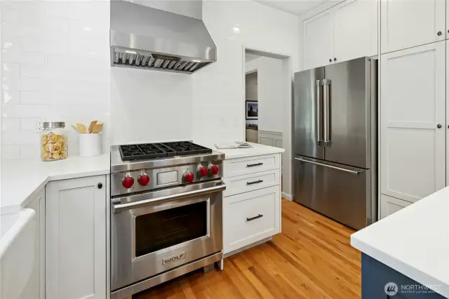 Another look at this wonderful, updated kitchen with a Wolf Dual Fuel Range, quality wood cabinetry, solid surface countertops, and modern subway tiled backsplash.