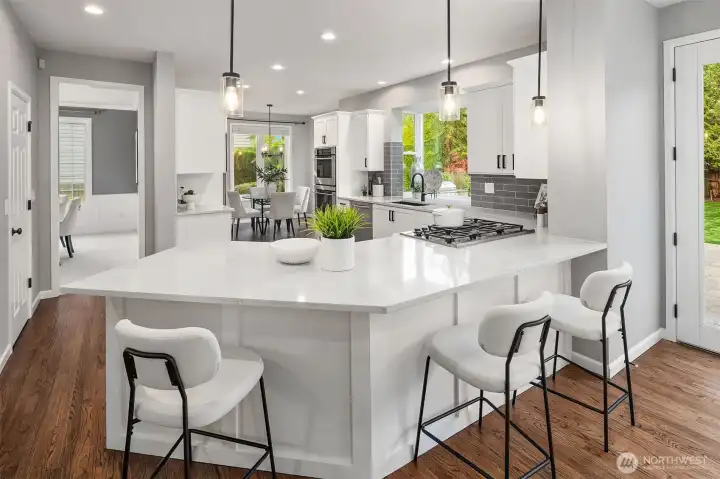 Chef's kitchen with premium stainless steel appliances, wine refrigerator, walk-in pantry, breakfast nook and abundant prep space.