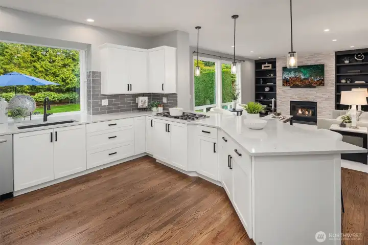 Gleaming quartz counters and subway tile backsplashes make this light and bright kitchen the heart of the home.