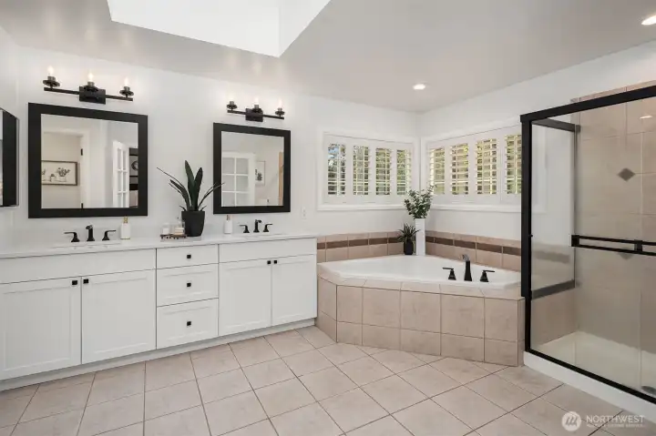 Updated, spa-inspired bathroom with dual vanities, and a spacious walk-in closet that includes hook-ups for a stackable washer and dryer.