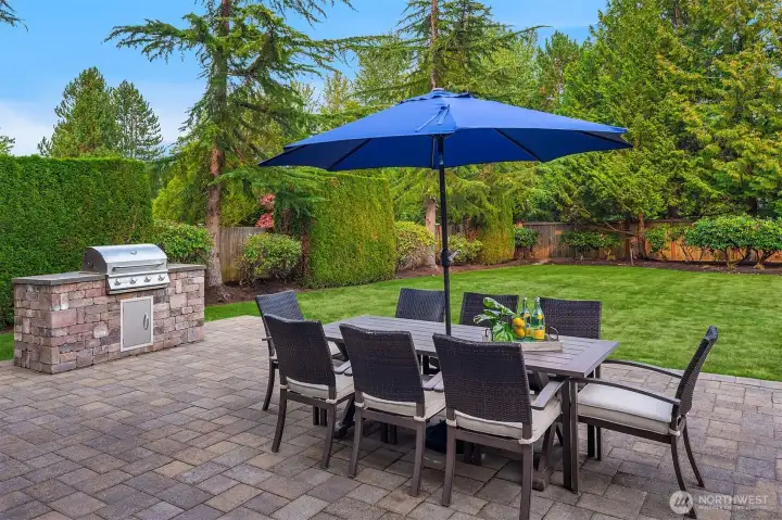 Entertain with ease on the expansive patio, featuring a built-in BBQ and plenty of room for al fresco dining, all set against a lush, private backyard.