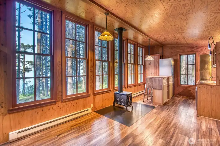 Main cabin upstairs living area shines with light from a wall of window.