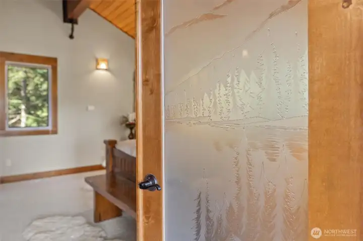 Beautiful custom glass on French Door leading into Primary Bedroom