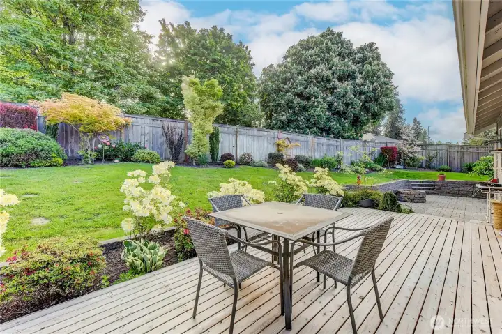 Beautifully landscaped back yard with large deck