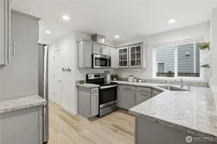 Plenty of room to move around this kitchen. Complete with granite countertops.
