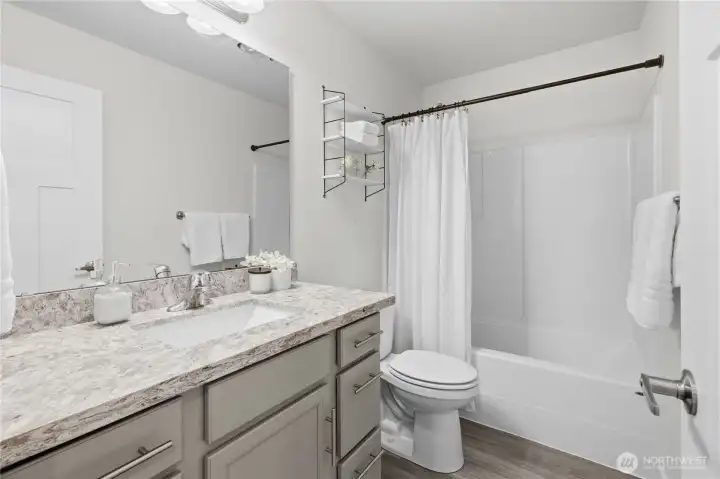 Primary bath with granite countertops and undermount sink.