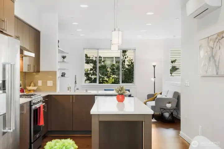 Open space from the dining room to the living room. The kitchen is the central focus.