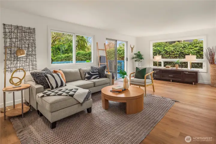 This oversized living room is one of 2 lounge areas on the main floor with new paint and new LVP flooring.