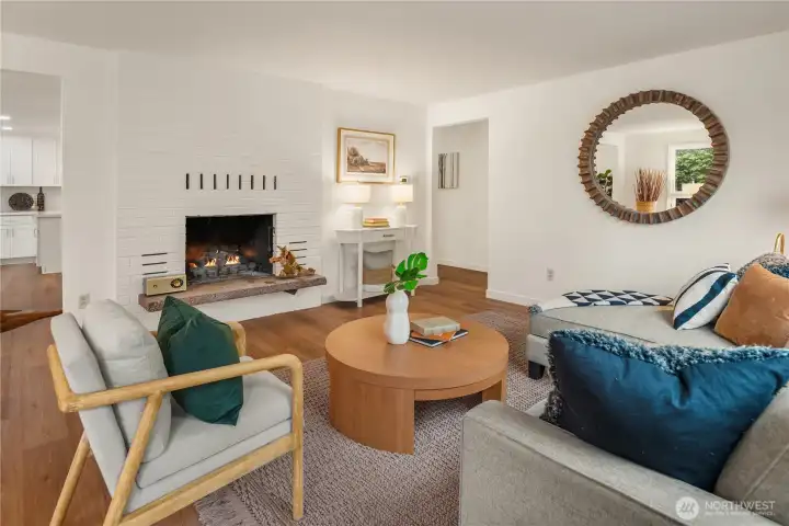 Looking across the main living room the dining room is off to the left and the formal entry and bedrooms through the doorway in the center. This home boasts a fantastic circular floorplan.