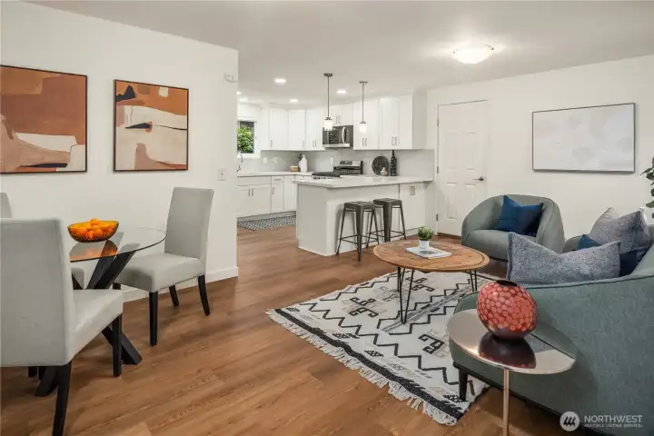 This picture shows off how big this room is with multiple arrangement opportunities. The door in the center leads to the attached 2 car garage.