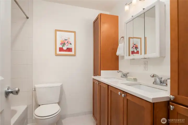 The main bathroom is enormous with dual undermount sinks, lots of storage and extensive tile on the floor and tub surround.