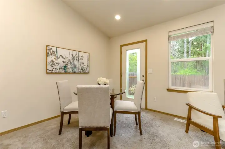 Dining room with back door access to the fully fenced backyard and patio.