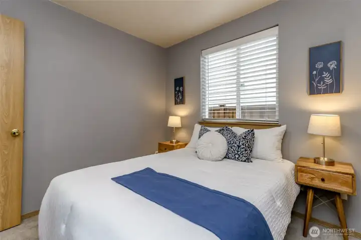 Guest room is next to the full bathroom and the window overlooks the side yard.