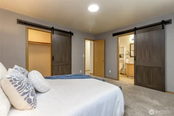 Primary bedroom facing the 5 piece bathroom.