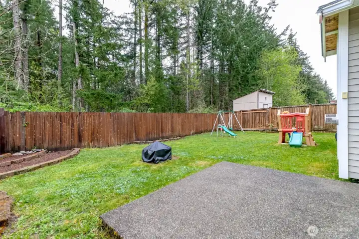 Fully fences backyard with patio, flower beds, fire pit and room for garden beds.