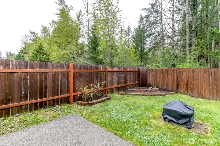 Lovely trees behind the fence offers privacy and beauty.