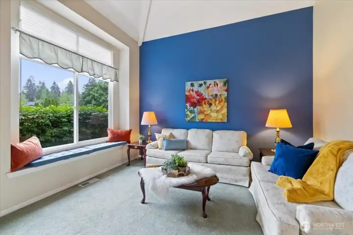 Cozy living room with a large picture window bringing in the light from the east