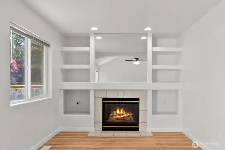 Easy-use gas fireplace just serviced! The surrounding built-in shelves are the perfect place to display your favorite books, decor, or mementos. The window here also allows for natural light and views of the amazing greenery out back. Easy-use gas fireplace just serviced! The surrounding built-in shelves are the perfect place to display your favorite books, decor, or mementos. The window here also allows for natural light and views of the amazing greenery out back.
