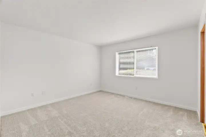 The main floor primary bedroom just off the kitchen and living space is superb! Brand new carpet underfoot is sure to delight. The main floor primary bedroom just off the kitchen and living space is superb! Brand new carpet underfoot is sure to delight.