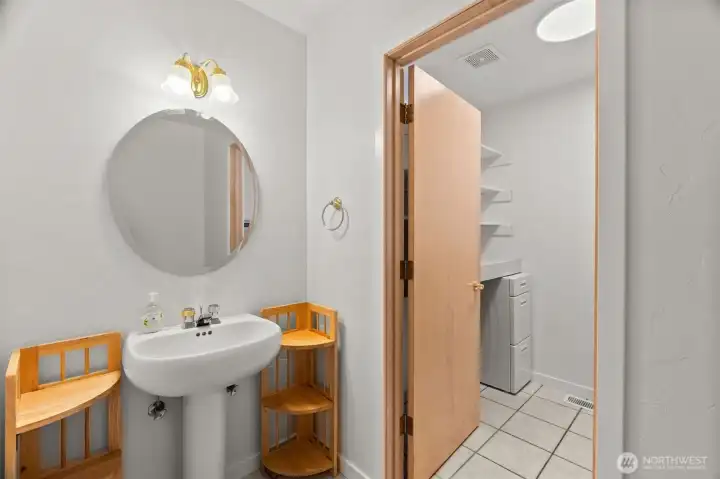 Off the main hallway is this fresh guest bath with pedestal sink, and dedicated laundry room access. Off the main hallway is this fresh guest bath with pedestal sink, and dedicated laundry room access.