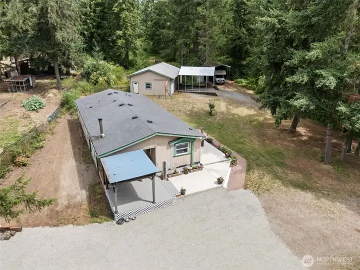 Aerial view of home, garage, carport and RV/Boat parking. Temporary items removed digitally.