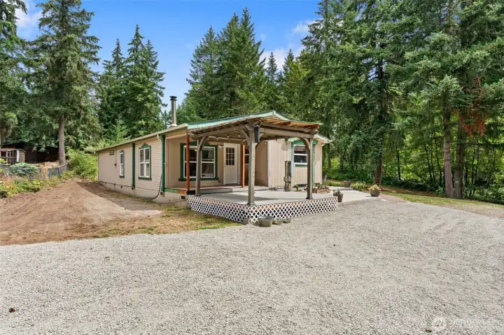 Exterior view of home and driveway. Temporary items removed digitally.