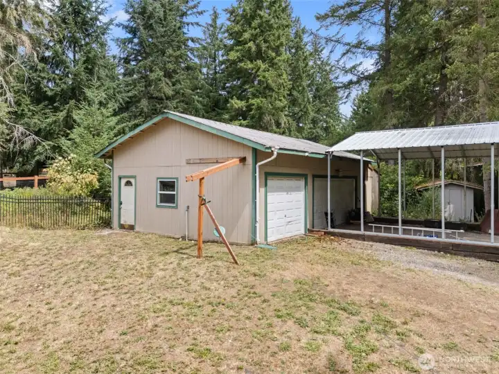 Exterior view of 3 car garage and 2 car carport.