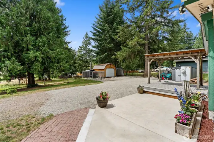 Large parking area, large shed and dog run. Front patio. Temporary items removed digitally.