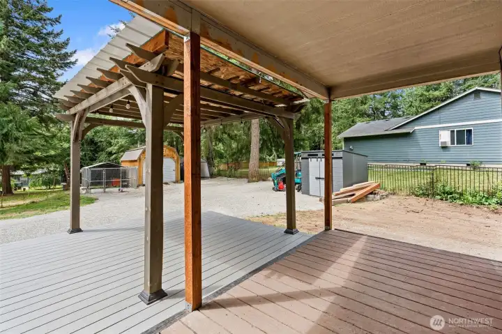 Covered front porch, parking, two sheds and dog run. Temporary items removed digitally.