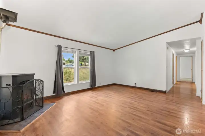 Large living room with pellet stove. Furniture removed digitally.