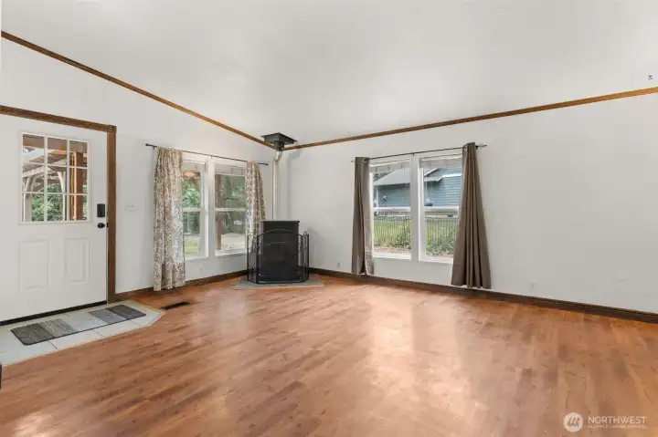Large living room with pellet stove. Furniture removed digitally.