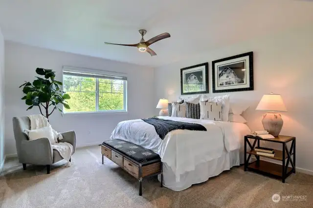 Generous primary bedroom has an inviting neutral pallete to go with any decor.