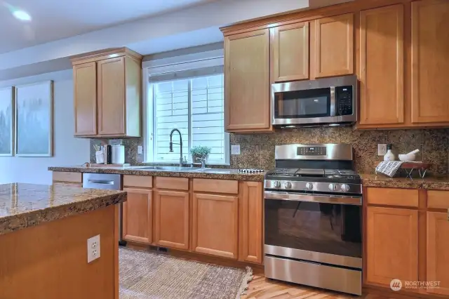 No shortage on sleek cabinetry to hold all your kitchen storage needs complemented by rich granite countertops.