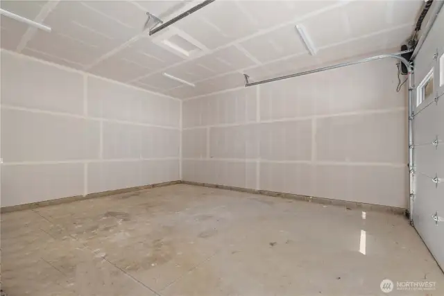 Huge heated garage with high ceilings and shop space.