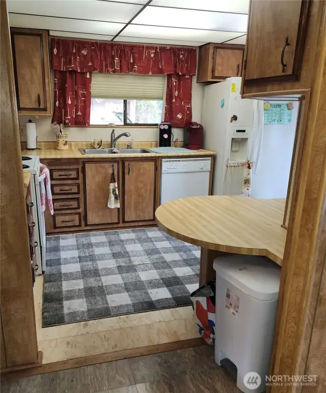 Another picture of the good sized kitchen with seating bar