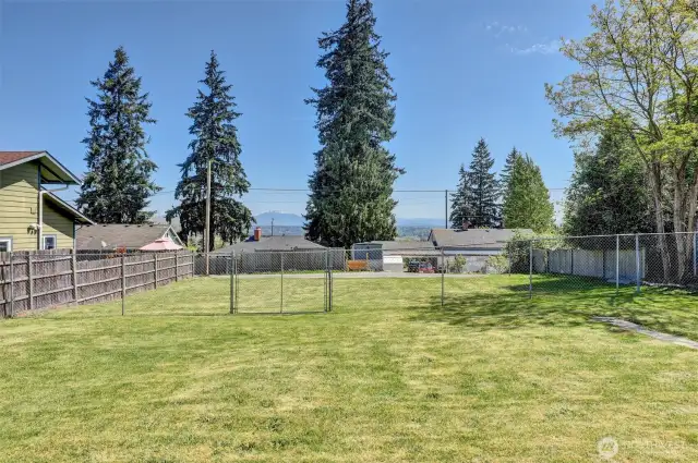 fenced backyard with mountain views