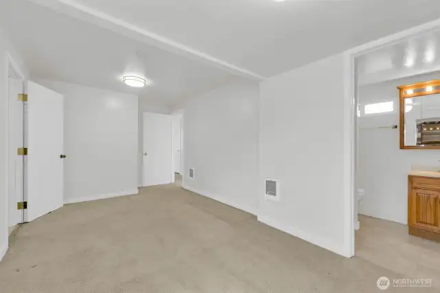 Primary bedroom with 3/4 bath and access to mud room