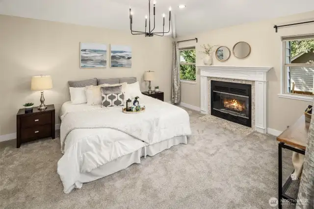 Large primary bedroom with another gas fireplace.
