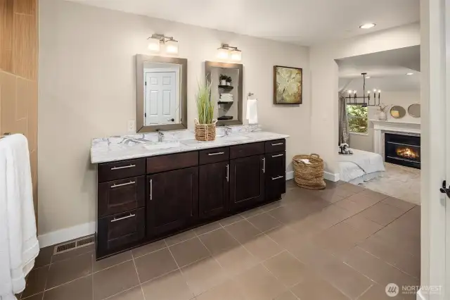 Luxurious primary bathroom with marble countertop vanity.