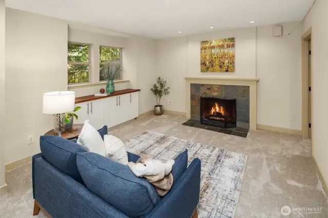 Basement living room with the last of the four fireplaces. Plenty of light in here!