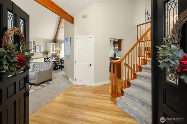 Double entry doors, vaulted ceilings, and a grand staircase make a welcoming entryway.