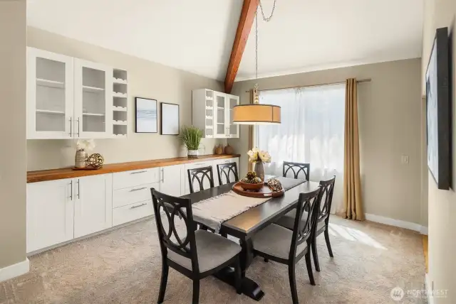 Dining room with buffet table and tons of built-in cabinet storage. Plus custom wine bottle shelves! Host large dinners here with so much room to serve the food and drinks.