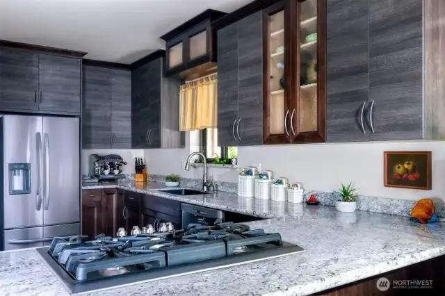 Well-appointed Chef's kitchen features SS appliances, gas stove, granite counters, no touch faucet & pleasing mix of cabinetry.