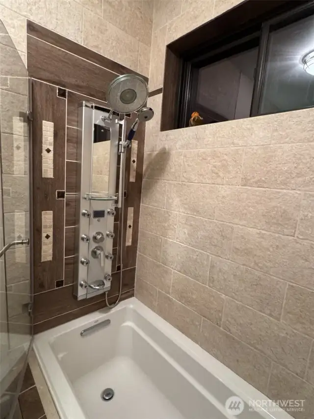 Luxury multi-jet shower panel, LED controls, and a soothing rain shower.