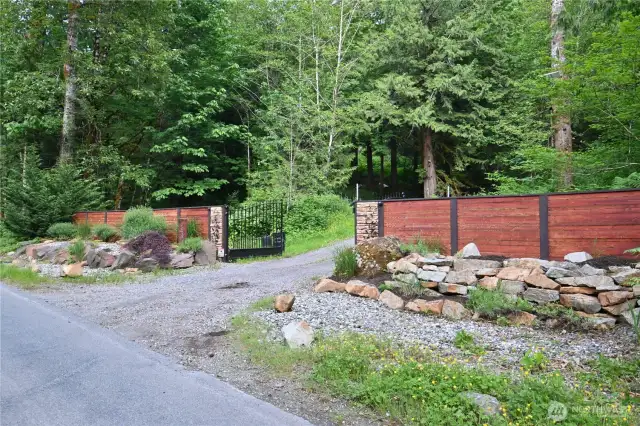 Enter through a custom, rock-lined security gate into an exceptional 8+acre retreat filled with surprises, versatility & charm!